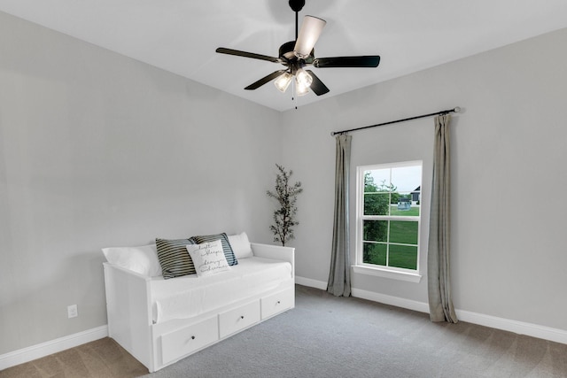 sitting room with carpet floors, a ceiling fan, and baseboards