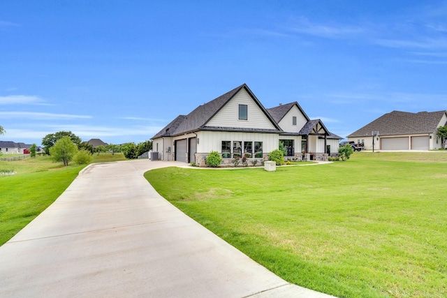 modern farmhouse style home with board and batten siding, an attached garage, concrete driveway, and a front yard