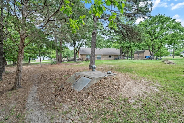 entry to storm shelter featuring a lawn