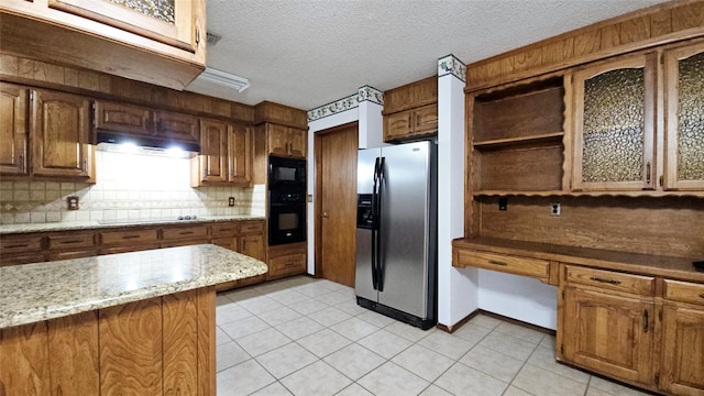 kitchen with decorative backsplash, a textured ceiling, open shelves, black appliances, and under cabinet range hood