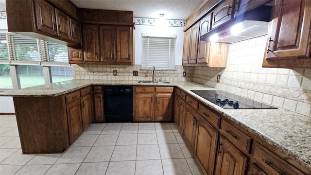 kitchen featuring decorative backsplash, a sink, black appliances, a peninsula, and wall chimney exhaust hood