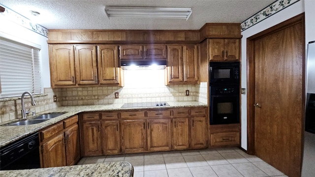 kitchen featuring exhaust hood, a textured ceiling, a sink, and black appliances