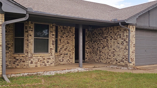view of property exterior featuring a porch, an attached garage, and roof with shingles