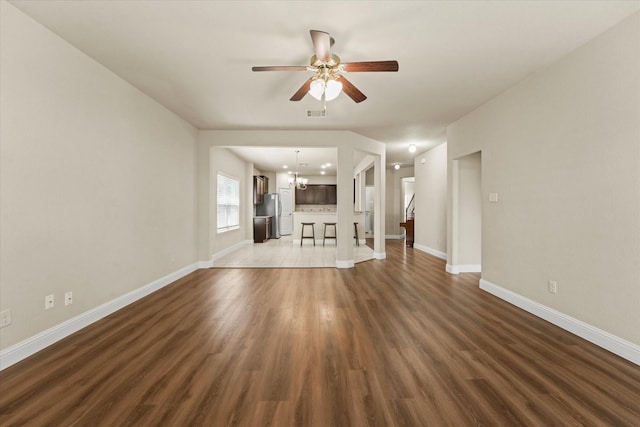 9933 Cottontail Ln, Mckinney, TX 75071 - unfurnished living room with a chandelier, ceiling fan, and wood finished floors