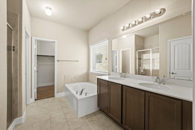 9933 Cottontail Ln, Mckinney, TX 75071 - full bathroom featuring a shower stall, a bath, a spacious closet, tile patterned flooring, and double vanity