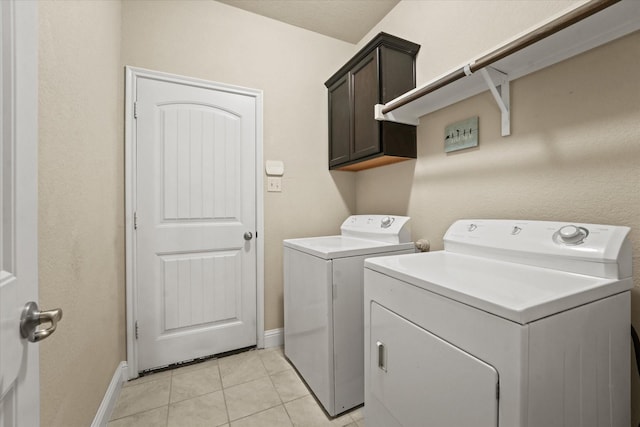 9933 Cottontail Ln, Mckinney, TX 75071 - clothes washing area featuring independent washer and dryer, cabinet space, baseboards, and light tile patterned floors