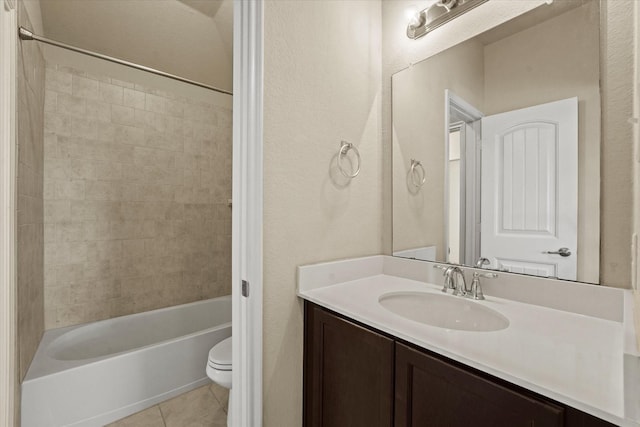 9933 Cottontail Ln, Mckinney, TX 75071 - bathroom with tile patterned flooring, toilet, vanity, bathing tub / shower combination, and a textured wall
