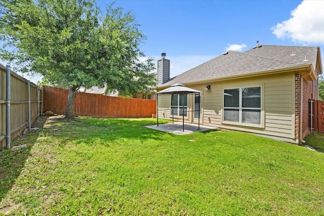 9933 Cottontail Ln, Mckinney, TX 75071 - back of property featuring a patio, a chimney, brick siding, and roof with shingles