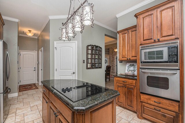 kitchen with ornamental molding, a center island, dark stone counters, brown cabinets, and stainless steel appliances