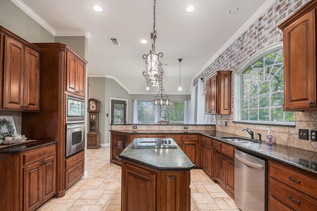 kitchen with a sink, ornamental molding, stainless steel appliances, and visible vents