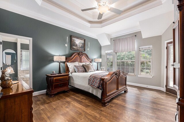 bedroom with baseboards, ornamental molding, a raised ceiling, and dark wood-style floors