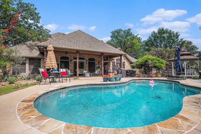 view of pool featuring a fenced in pool, a gazebo, and a patio area