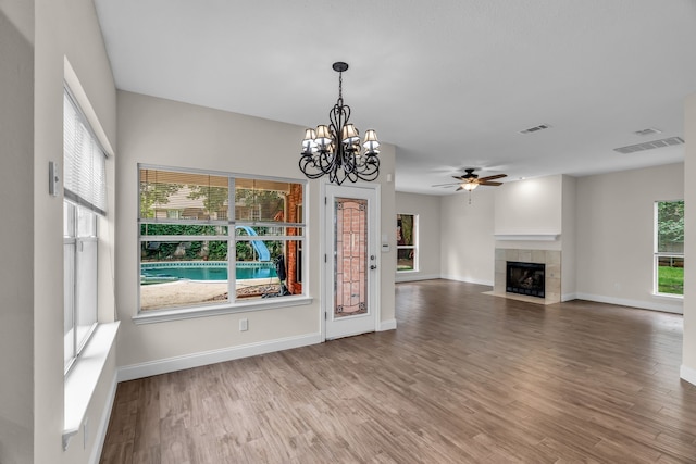 2085 Idlewood Dr, Grapevine, TX 76051 - unfurnished living room with ceiling fan, wood finished floors, a chandelier, and a tile fireplace