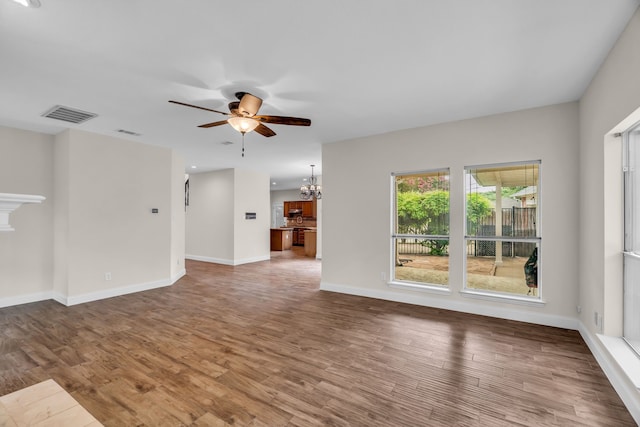 2085 Idlewood Dr, Grapevine, TX 76051 - unfurnished living room featuring a ceiling fan, a chandelier, and wood finished floors