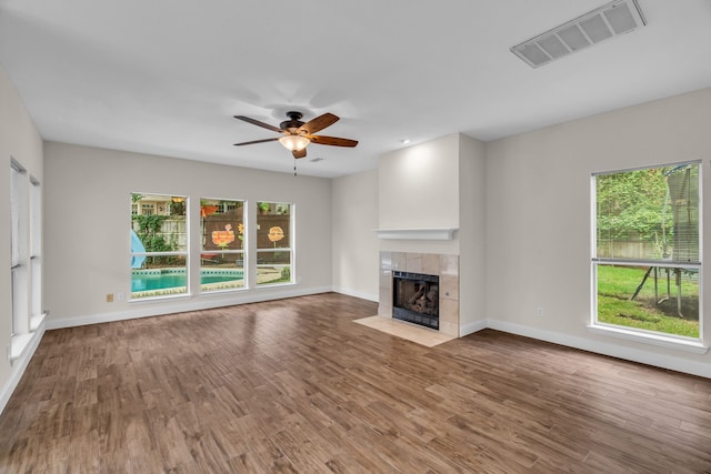2085 Idlewood Dr, Grapevine, TX 76051 - unfurnished living room with a tile fireplace, ceiling fan, and wood finished floors