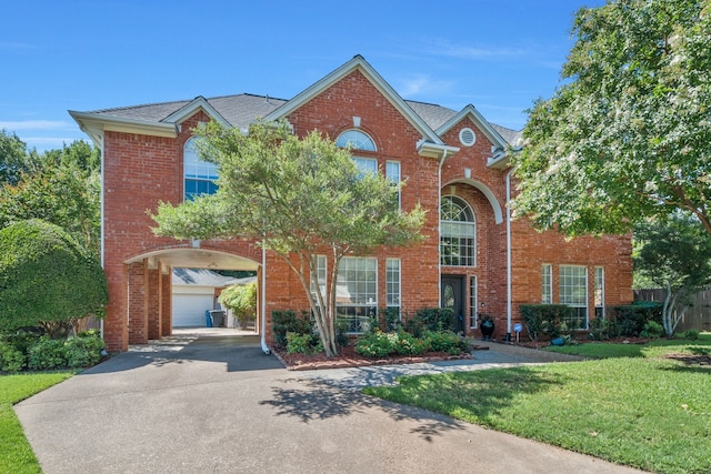 2085 Idlewood Dr, Grapevine, TX 76051 - traditional-style house featuring a front lawn, brick siding, and driveway