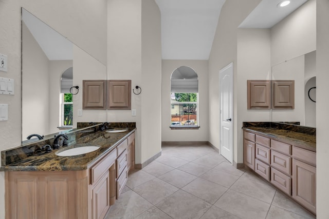 2085 Idlewood Dr, Grapevine, TX 76051 - full bathroom featuring high vaulted ceiling, healthy amount of natural light, double vanity, and tile patterned flooring
