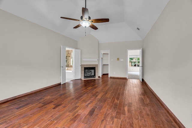 2085 Idlewood Dr, Grapevine, TX 76051 - unfurnished living room with ceiling fan, dark wood-style flooring, a tile fireplace, and high vaulted ceiling