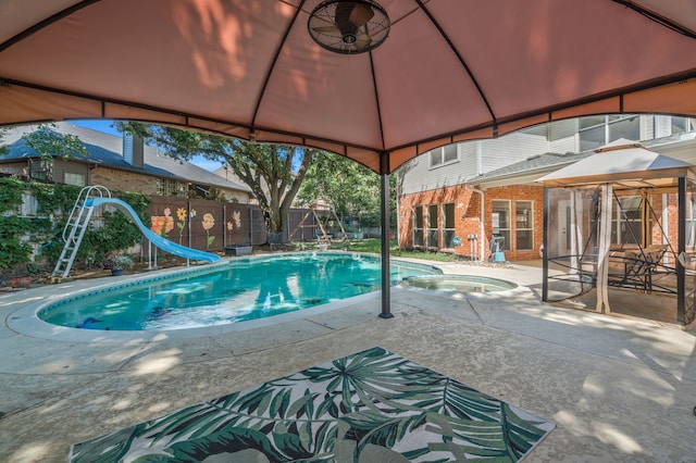 2085 Idlewood Dr, Grapevine, TX 76051 - view of swimming pool featuring a gazebo, a water slide, a patio, and a fenced backyard