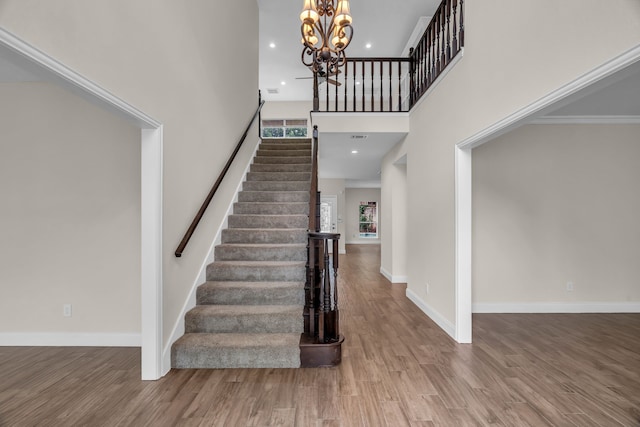 2085 Idlewood Dr, Grapevine, TX 76051 - staircase featuring a towering ceiling, a chandelier, and wood finished floors