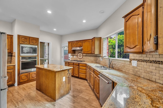 2085 Idlewood Dr, Grapevine, TX 76051 - kitchen featuring stainless steel appliances, a center island, brown cabinetry, recessed lighting, and decorative backsplash