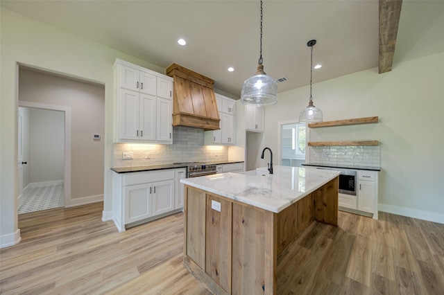 kitchen featuring open shelves, light wood finished floors, and tasteful backsplash