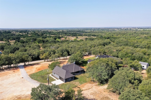 birds eye view of property featuring a wooded view