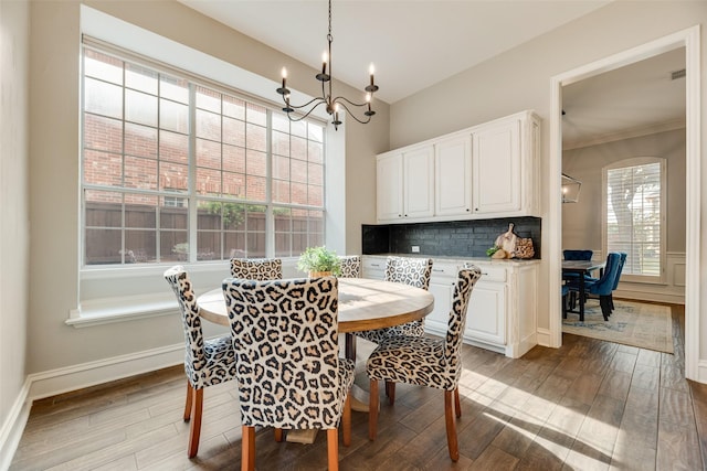 1355 Crockett Dr, Frisco, TX 75033 - dining room featuring light wood-style floors, a chandelier, baseboards, and ornamental molding