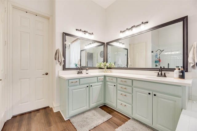 1355 Crockett Dr, Frisco, TX 75033 - full bath featuring double vanity, a tile shower, and wood finished floors
