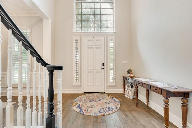 1355 Crockett Dr, Frisco, TX 75033 - foyer with stairway, wood finished floors, a towering ceiling, crown molding, and baseboards
