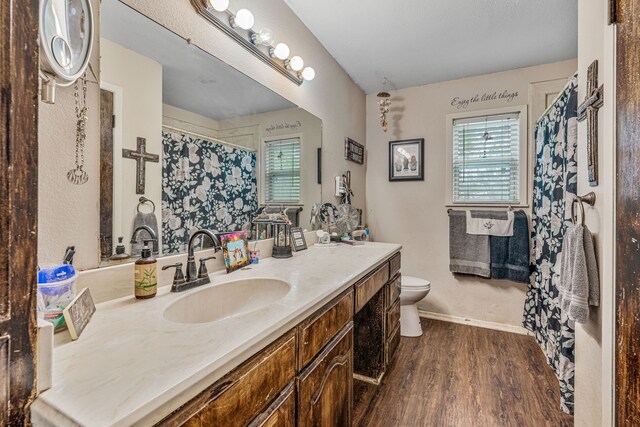 372 County Road 477, Stephenville, TX 76401 - bathroom with a shower with curtain, wood finished floors, baseboards, vanity, and toilet