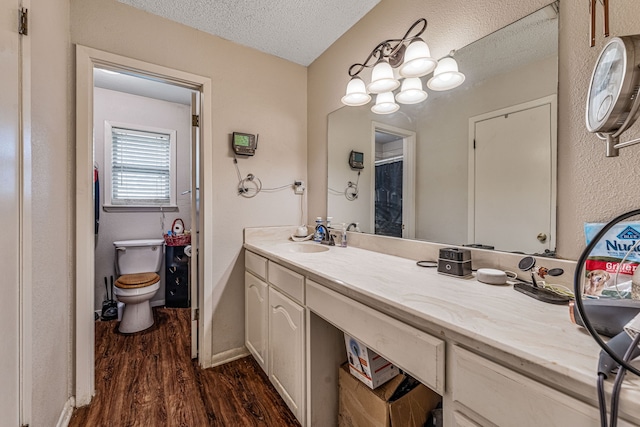 372 County Road 477, Stephenville, TX 76401 - bathroom featuring toilet, a textured ceiling, wood finished floors, and vanity