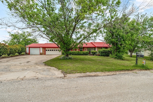 372 County Road 477, Stephenville, TX 76401 - single story home with a garage, driveway, metal roof, and a front yard