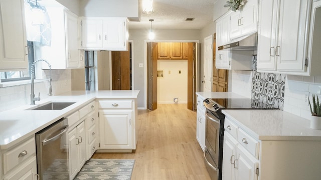 75 Delmore Dr, Hillsboro, TX 76645 - kitchen featuring stainless steel appliances, under cabinet range hood, a sink, and decorative backsplash