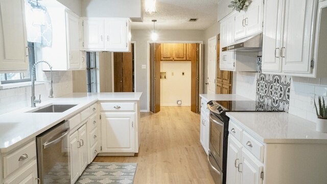 75 Delmore Dr, Hillsboro, TX 76645 - kitchen featuring stainless steel appliances, under cabinet range hood, a sink, and decorative backsplash