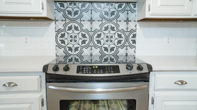 interior details featuring light countertops, white cabinetry, stainless steel electric stove, and tasteful backsplash