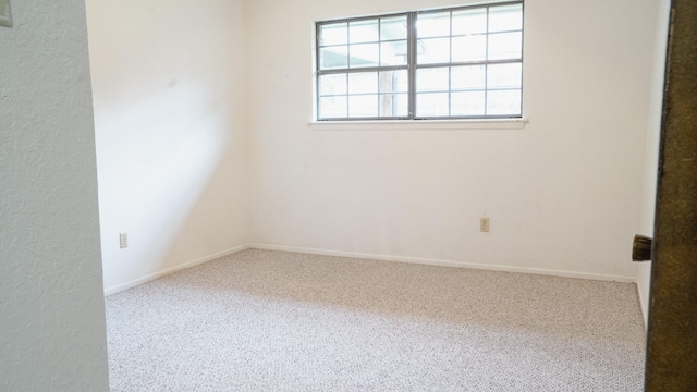 empty room with carpet floors and baseboards
