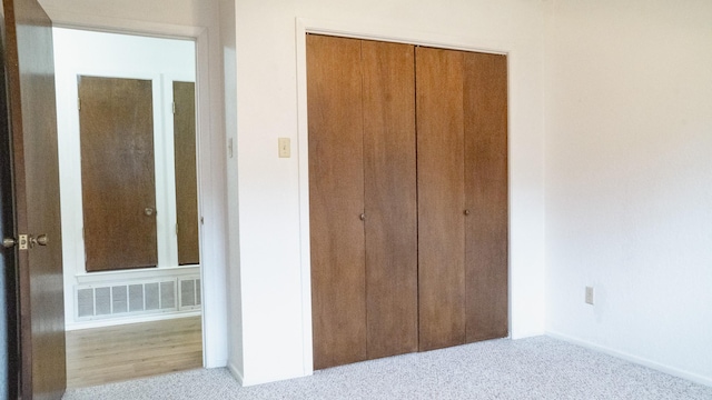 unfurnished bedroom featuring baseboards, a closet, and visible vents