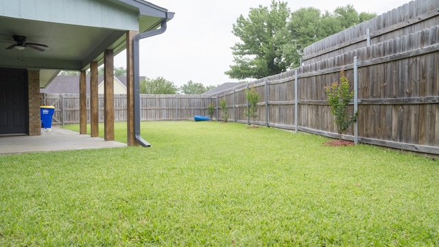 view of yard with a patio, a ceiling fan, and a fenced backyard