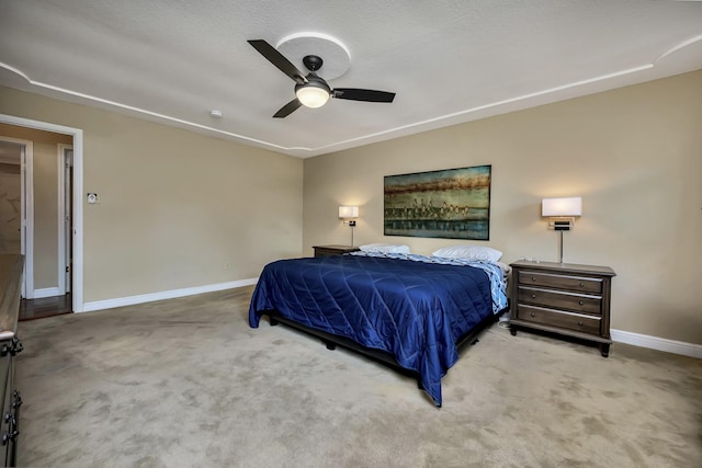 carpeted bedroom featuring baseboards and a ceiling fan