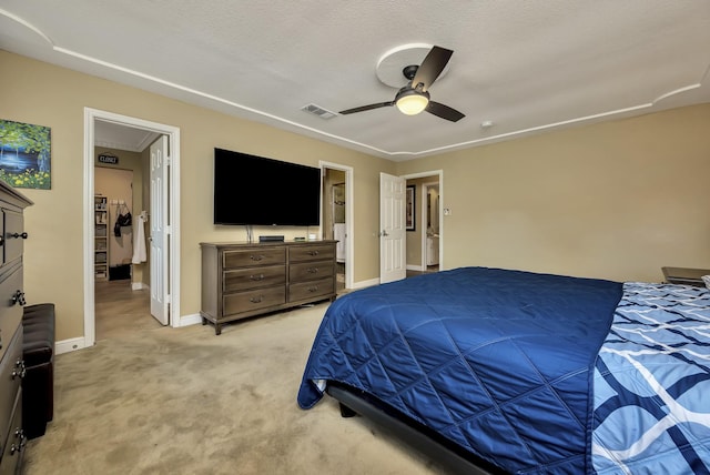bedroom with visible vents, a ceiling fan, baseboards, and light carpet