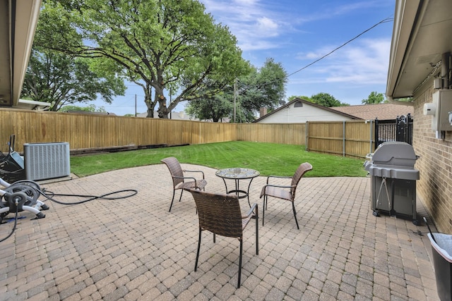 view of patio featuring central AC unit, a fenced backyard, and a grill