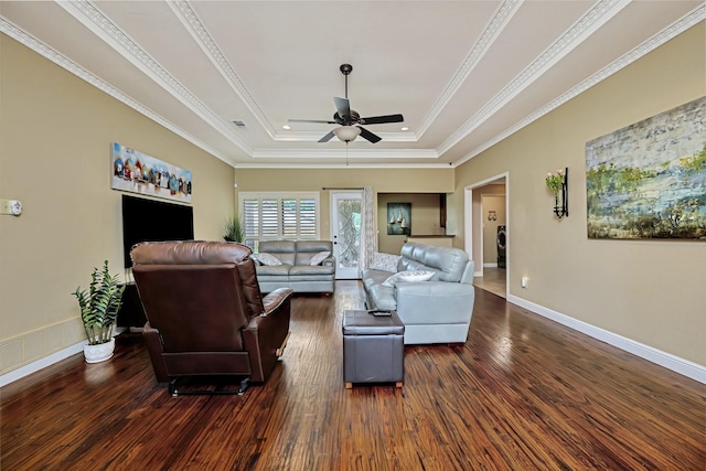 living area featuring a ceiling fan, visible vents, crown molding, dark wood-style floors, and a tray ceiling