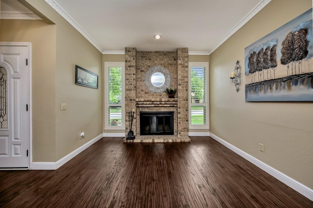 unfurnished living room featuring baseboards, ornamental molding, wood finished floors, and a fireplace