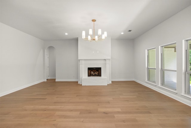 unfurnished living room with an inviting chandelier, recessed lighting, and a wealth of natural light