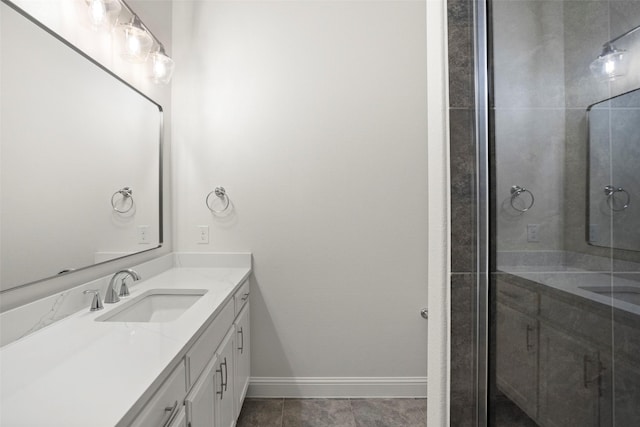 full bathroom featuring vanity, baseboards, and a stall shower
