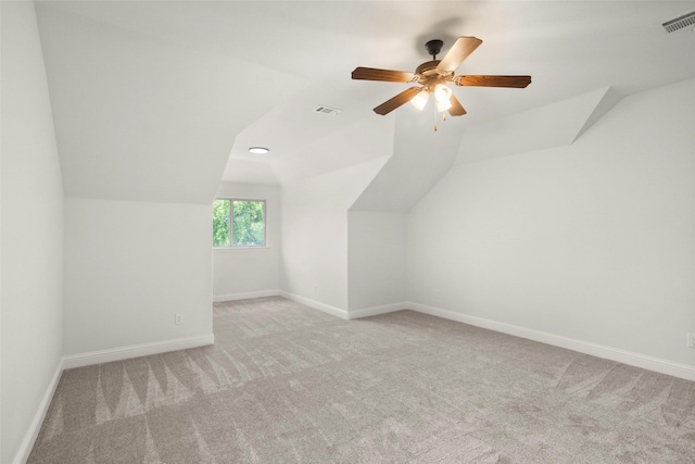 bonus room with visible vents, light carpet, baseboards, ceiling fan, and vaulted ceiling