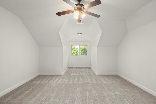 additional living space featuring carpet floors, baseboards, vaulted ceiling, and visible vents