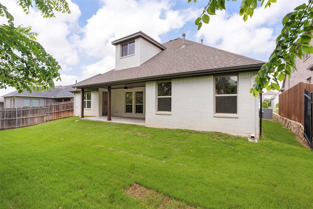 back of house with a ceiling fan, a lawn, a fenced backyard, a patio, and a shingled roof