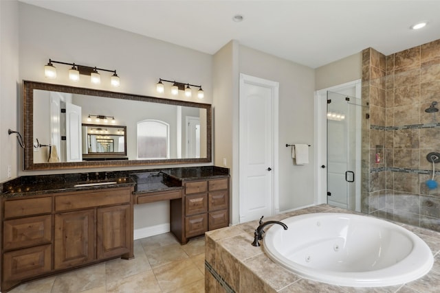 bathroom with a jetted tub, vanity, a shower stall, and tile patterned floors